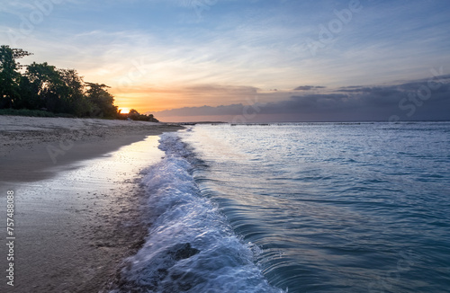 Sunrise on the famous Pacific Ocean. Beautiful summer sea view. Amazing sunrise. Morning landscape. Waves with foam. Romantic vacation spots Bali island Indonesia