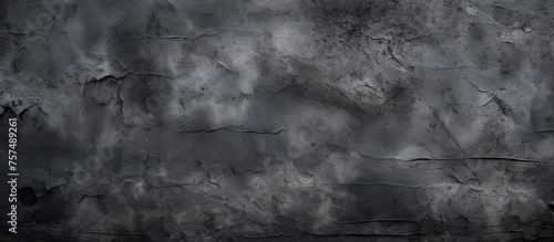 A close up of a monochrome black wall featuring a grey texture resembling cumulus clouds in a natural landscape. The skys darkness captured in monochrome photography