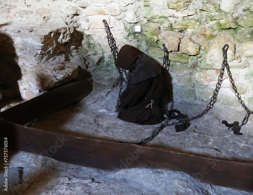 A monk imprisoned in a dungeon in a castle