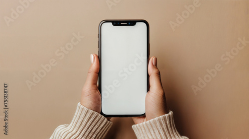 Hand Holding a Phone with White Blank Screen . Work at home on the phone. An empty white mockup screen.