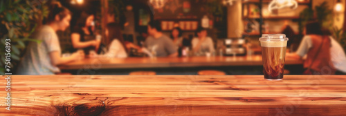 Empty wood table top with blurred background of people sitting in a coffee shop, fast food restaurant or pub for product display montage. Concept for advertising design, layout presentation.banner