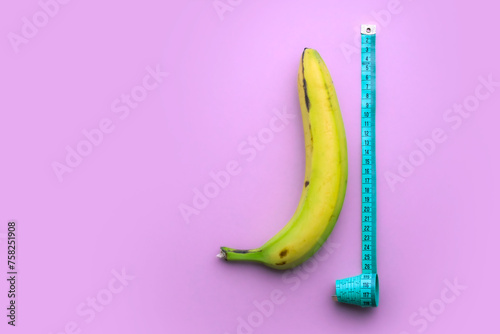 Banana with measuring tape on pink background. Men penis size concept. Flat lay, top view, copy space.
