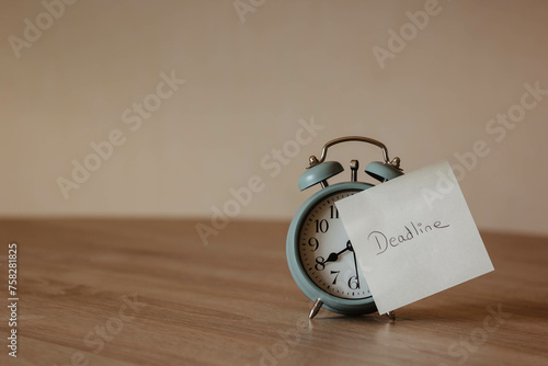 alarm clock with pos-it and the word "Deadline". Deadline in projects. Objectives and goals. Due date. delay in business. time limit. Target