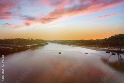 Landscape evening sunset view over the river with reflection surrounded by mangrove forest. 