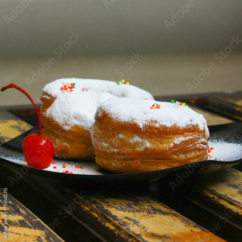 The Cronut (a portmanteau of croissant and doughnut) is a pastry created and trademarked in 2013 by the French pastry chef Dominique Ansel. It resembles a doughnut and is made from croissant-like doug