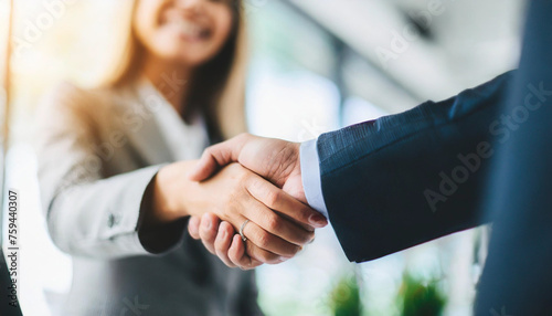 successful businessmen shaking hands with focus on women's hands in agreement