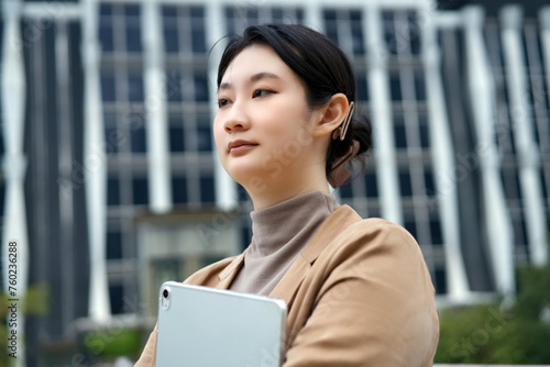 Young Professional Woman Using Tablet in City