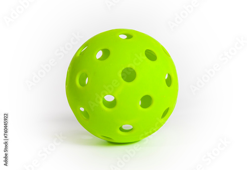 A green pickleball ball isolated on a white background