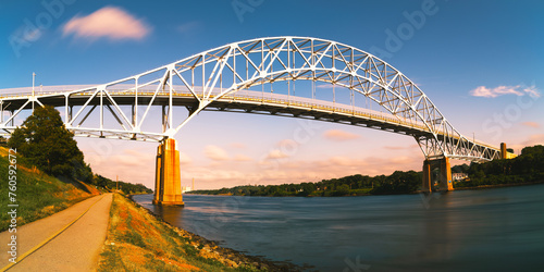 Sagamore Bridge the Landmark Architecture and Riverbank Footpath at Twilight along Cape Cod Canal on Cape Cod, Massachusetts, USA, Long Exposure photo