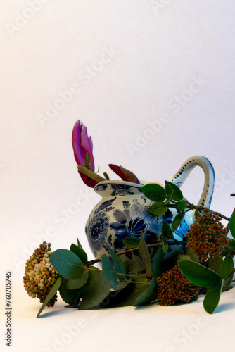 delft blue jug with sprig of magnolia flowers and sprig of eucalyptus