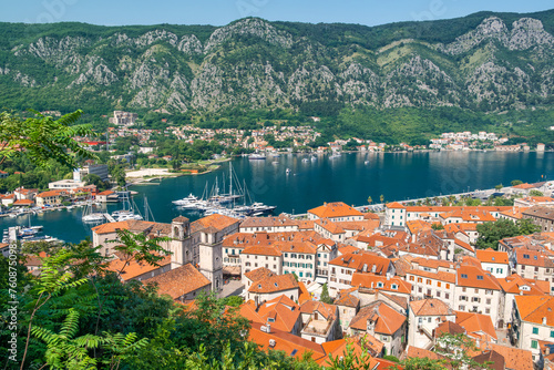 Aerial view of Kotor old town with orange rooftops and marina in Kotor bay with boats and yachts, Montenegro. Summer vacation resort on Adriatic fjord in summer day. Travel destination