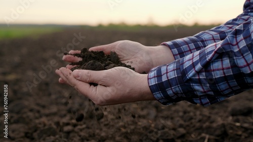 Agricultural industry. Farmer hands hold fertile soil, natural fertilizer, compost. Farmer checks composition of soil before sowing. Man, woman holding land in hands in close-up. Concept agriculture