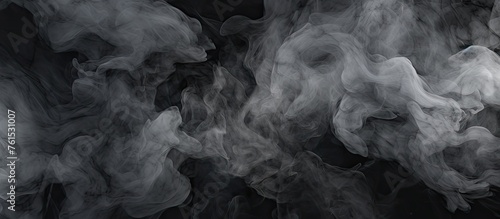 A close up of grey smoke billowing out of a pipe against a black background, resembling a cumulus cloud. This monochrome photograph captures a meteorological phenomenon in the darkness