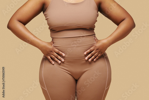 Cropped image of curvy Black woman putting hands on waist