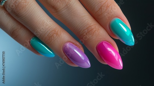 Multicolored almond-shaped nail design with turquoise and pink polish. Close-up beauty shot for design and print