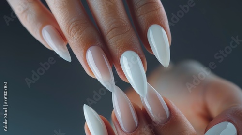 Hand with long white twisted nails. Close-up studio shot. Creative nail design and art concept for posters and banners