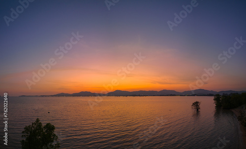 Orange sky at sunset above Khao Khad viewpoint Phuket. Beautiful The glare of the sun shone through the mangroves. Reflections of the sun in the mangroves on the seaside of the mangroves.