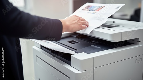 an office worker is using a printing machine