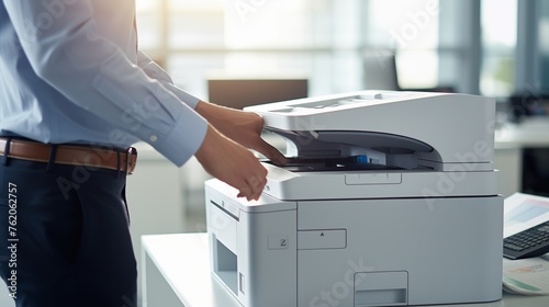 an office worker is using a printing machine