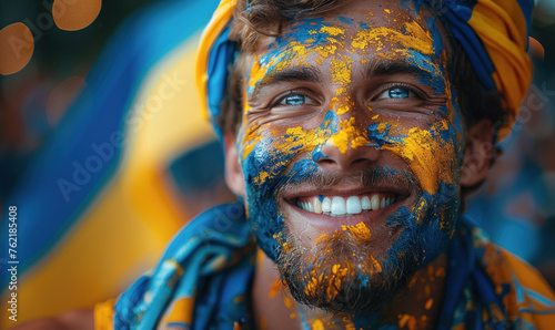 Portrait of a passionate male Ukrainian fan celebrating at a UEFA EURO 2024 football match, his face painted with the colors and patterns of the Ukraine flag, radiating enthusiasm and national pride