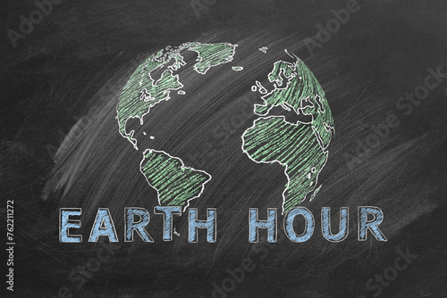 Globe with lettering EARTH HOUR hand drawn in chalk on a school blackboard. Save the World. Save our planet.