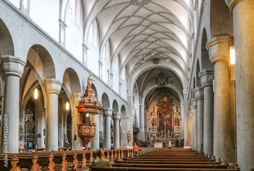 Lovely view of the Romanesque nave, vaulted in baroque style with monolithic columns from the 11th century and the pulpit from 1680, inside the famous Constance Cathedral in the old town of Constance.