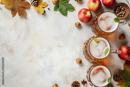 Three glasses of beer with apples and nuts on a table