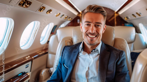 A smiling rich young businessman is flying in a luxury private jet.
