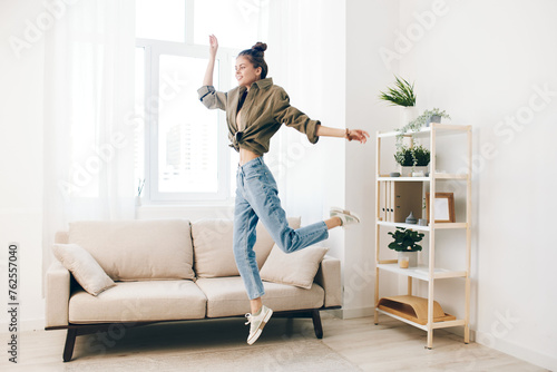 Playful Jumping: A Joyful Woman Dancing and Singing in a Carefree Home Interior