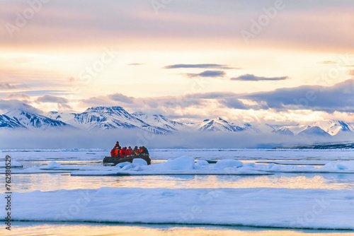 Beautiful arctic landscape view with people in a inflatable boat