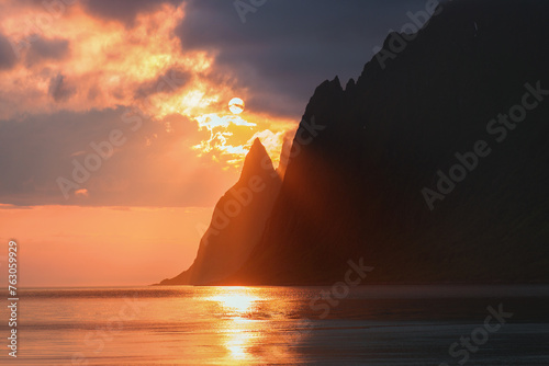 Senja island sunset landscape in Norway calm sea and rocky mountains scandinavian landmarks travel beautiful destinations Ersfjord beach northern nature midnight sun summer season