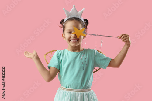 Cute little fairy with wand on pink background