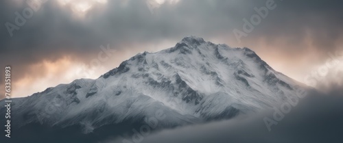 Mountain covered in snow under a cloudy sky