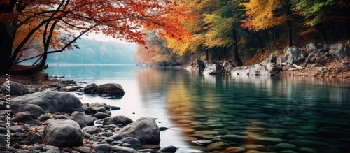 Rushing river with rocks and trees, blurred water, autumn landscape