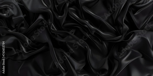Luxurious black silk texture displayed in a fluid wave pattern, ideal for high-end background or textile design.