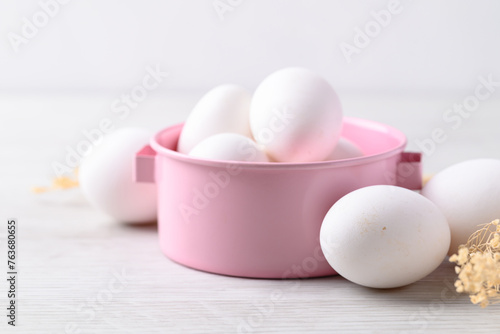 Organic white leghorn egg from free range farm in pink bowl