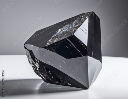 black natural gemstone rock stone of obsidian isolated in bright background