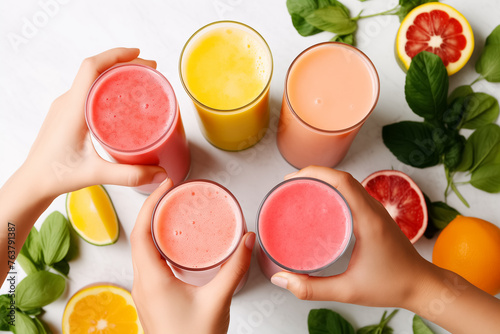 Assortment of Fresh Fruit Smoothies in Hands on a Bright Background