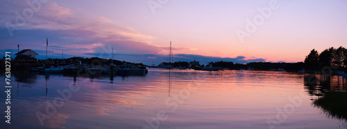 Cape Cod Sunrise Seascape Panorama at Quissett Harbor in Falmouth, Massachusetts, USA, a tranquil twilight coastal beauty with moored boats under warm pink dawn break