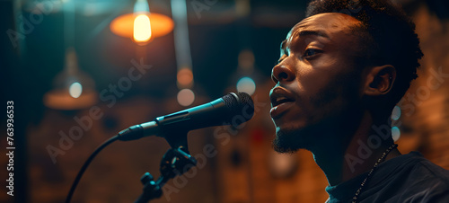 Intense expression of a male singer performing live, the emotion captured as he sings into a microphone in a warm, ambient setting.