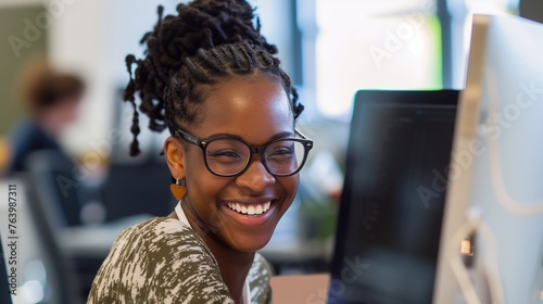 Quickness of mind and decisions. Black female office employee works at the computer. Communication between colleagues in the workplace, friendly relations in corporate culture