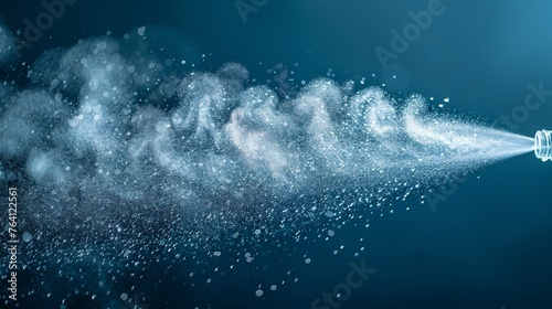 Spray of water from a bottle on a blue background. Intended for web sites, posters, cards, and wallpapers. Fog spray elements.