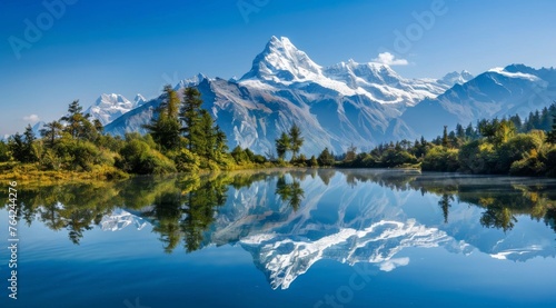 A beautiful mountain range with a lake in the foreground. The lake is reflecting the mountains and the sky
