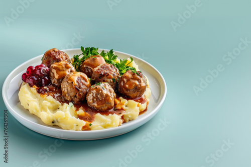 Traditional swedish meatballs with meat sauce and mashed potatoes on a plate. Kottbullar. Light blue color background, side view. Space for text.