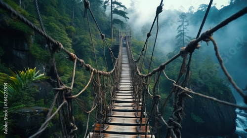 Old hanging bridge in tropical forest, vintage suspension wood path in musty jungle. Concept of travel, journey, lost world, nature, adventure movie