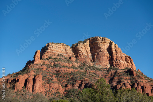 View of red rock bluffs in Sedona, Arizona desert landscape during sunny day