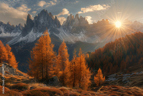 In the autumn of nature, in an alpine valley with dark brown larch trees and orange foliage atop high mountains in northern Italy, the sun shines through them. The mountain range has snowcapped peaks.