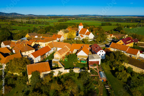 Picturesque aerial view of small Czech village Cakov surrounded by green and yellow trees and fields
