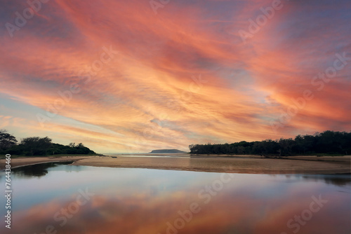 Colorful evening sunset reflection over the river surrounded by mangrove forest. Coffs Harbour, Australia. 