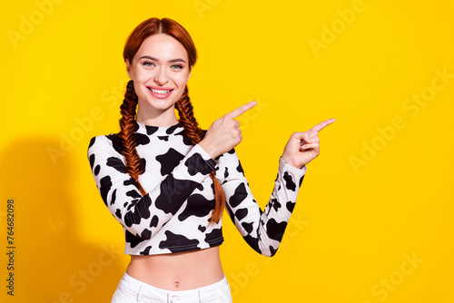 Photo of excited cheerful lady dressed cowskin top showing two fingers empty space isolated yellow color background